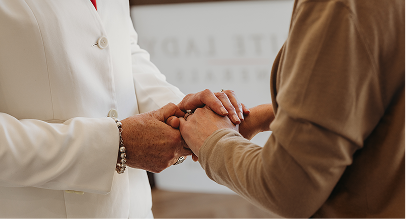 funeral director holding hands with family