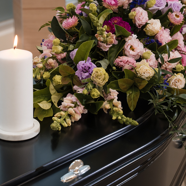 floral arrangement on coffin